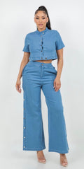 Woman wearing light blue denim two-piece set with cropped jacket and wide-leg pants