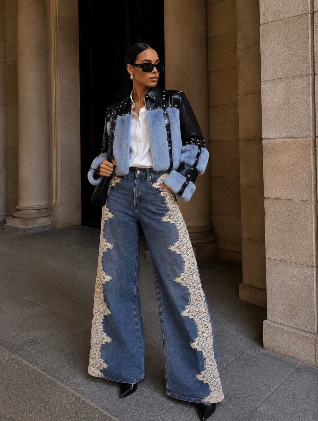 Woman wearing lace panel wide-leg jeans with black leather jacket with blue fur trim